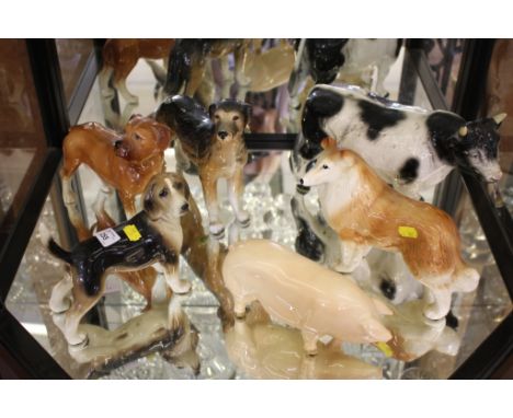 Melba ware figures of two dogs and a bull, and three other figures
