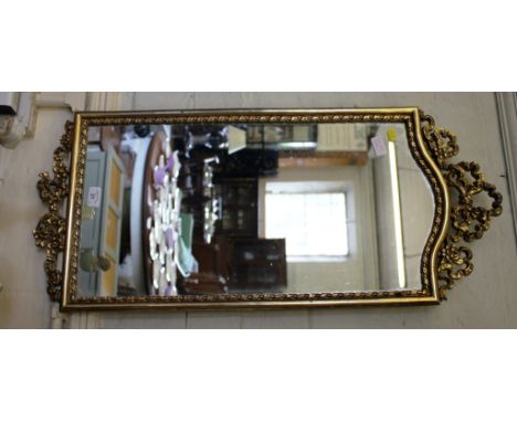 A giltwood wall mirror, with ribbon garland frame, 87cmx 39cm and an onyx hall table, with column supports, 62cm wide