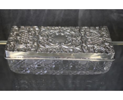 A glass oblong trinket box with silver lid decorated in relief, Chester 1901