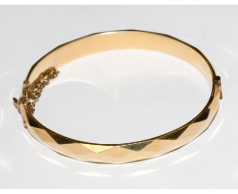 A gold colour metal bangle