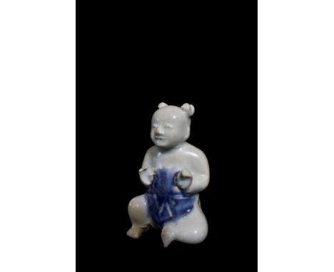 Ca Mau: Figure of a seated boy in blue and white, with R&G McPherson label, 8cm high