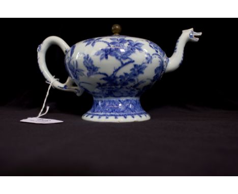 A Chinese blue and white teapot of pedestal form, with floral decoration and dragon spout, R&G McPherson label, dated to Yong