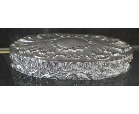 A Victorian oblong silver trinket box decorated on all sides in relief, Birmingham 1900