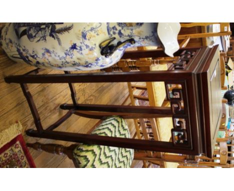 A Chinese hardwood torchere stand, the square top with square scroll frieze on moulded square section legs joined by stretche