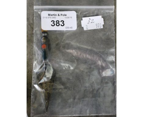 A silver page marker in the form of a trowel 