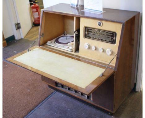 A walnut cased radiogram, with Regentone tuner and  Collaro turntable, the fall front over a speaker grille and plinth base, 