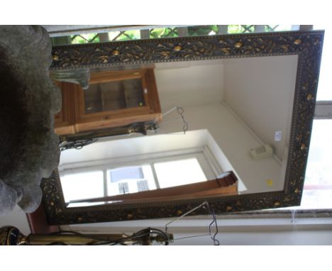 An Edwardian style giltwood wall mirror, the bevelled plate within a floral frame, 100cm x 70cm