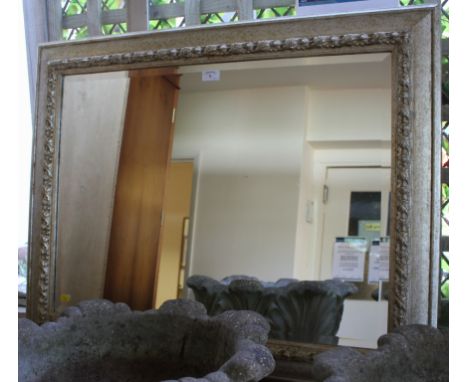 A silver coloured painted wall mirror, with bevelled plate and foliate carving, 76cm x 95cm