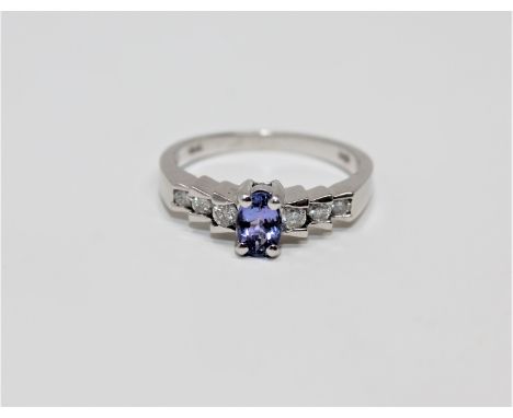 A 14ct white gold tanzanite and diamond ring, size N. 