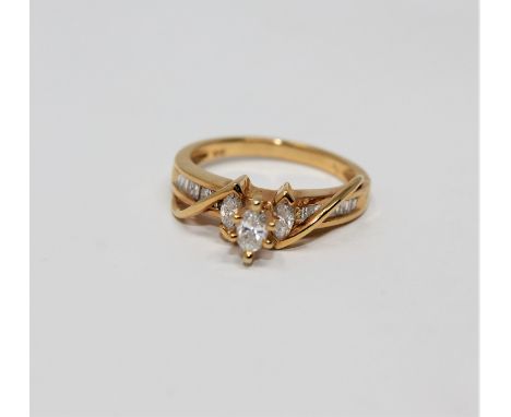 A 14ct gold marquise and baguette-cut diamond ring, size K. 