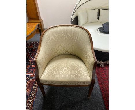 A mahogany framed tub chair upholstered in golden classical print 