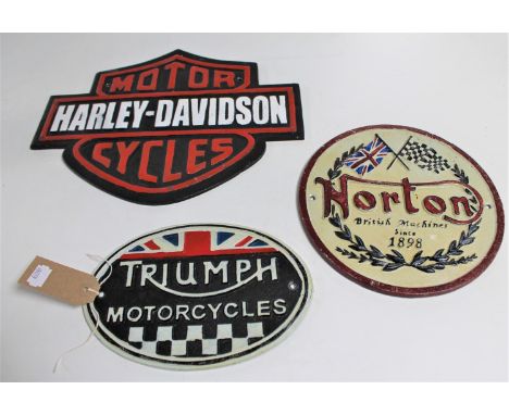 Three cast iron signs : Triumph, Norton and Harley Davidson 