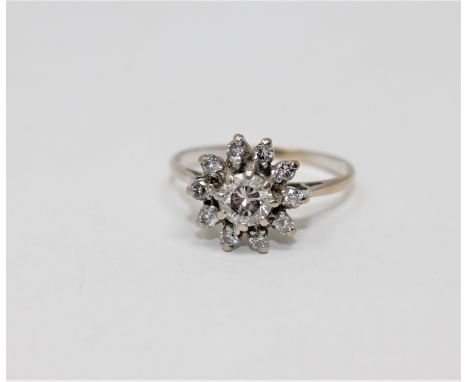 An 18ct gold diamond cluster ring, the principal brilliant-cut stone weighing approximately 0.50 carat, size P1/2