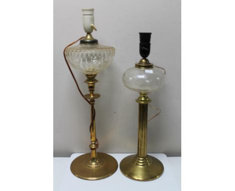 An antique brass paraffin lamp converted to a table lamp and one further similar lamp 