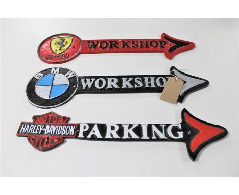 Three cast iron arrows : Ferrari, BMW workshops, Harley Davidson motor cycle parking 