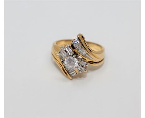 A 14ct gold diamond set ring, the principal diamond weighing an estimated 0.30 carat, further set with baguette-cut stones, s