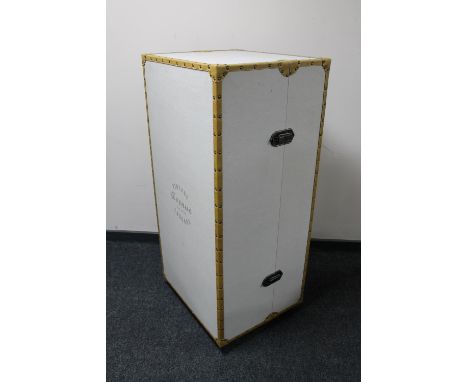 An early twentieth century canvas bound shipping trunk on castors fitted with shelves 