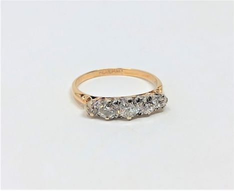 An 18ct gold three stone diamond ring, approximately 0.75 carat, size M. 