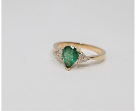 A 14ct gold emerald and diamond ring, the pear-cut emerald weighing 0.71 carat, the total diamond weight 0.13 carat, size L1/