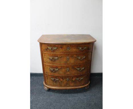 A 19th century continental mahogany and walnut bow fronted four drawer chest 