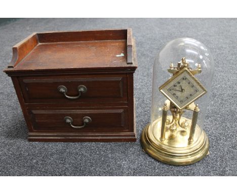 An Edwardian mahogany counter top two drawer chest and a German Kunda brass anniversary clock under glass dome 