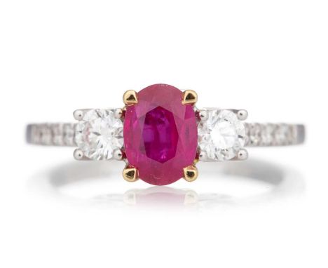 RUBY AND DIAMOND RING set with an oval ruby flanked by diamonds, in eighteen carat white gold, size MQty: 4.1g