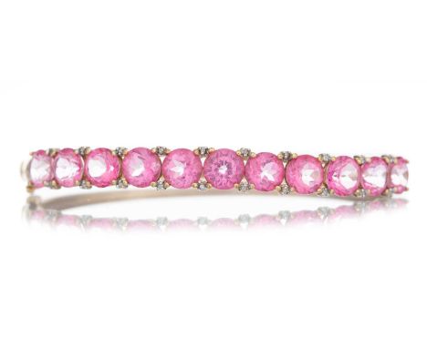 PINK GEM SET BANGLE the round pink gems interspaced by diamond chips, marked 9KQty: 14g