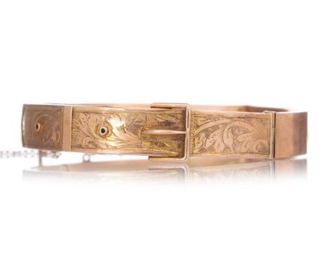 VICTORIAN NINE CARAT GOLD BANGLE LATE 19TH CENTURY  modelled with a buckle form and engraved leaf decoration Qty: 10.4gHeavil