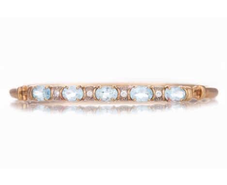 TOPAZ AND GEM SET BANGLE set with alternating stones, unmarkedQty: 6.8g