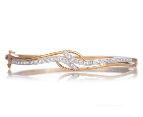 DIAMOND BANGLE of wave form, set with diamond chips, marked 375Qty: 8.7gGenerally worn.Scratched etc.&nbsp;Diamonds opaque.&n