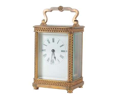 A FRENCH BRASS CARRIAGE CLOCK 19th century, the enamel dial with roman numerals and blue steel hands, the case with foliate c