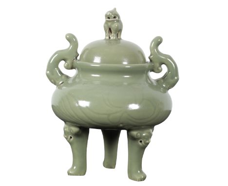 A CHINESE PORCELAIN CELADON GLAZED LIDDED TRIPOD CENSER 19th century, the lid with a mythical beast finial, the body twin han