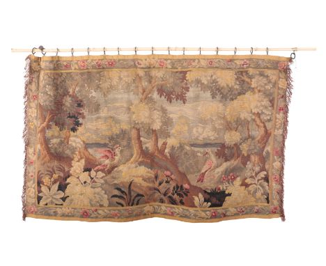 A 17TH CENTURY STYLE HANGING TAPESTRY depicting birds in a woodland setting, 106cm high x 172cm wide, with bamboo hanging pol