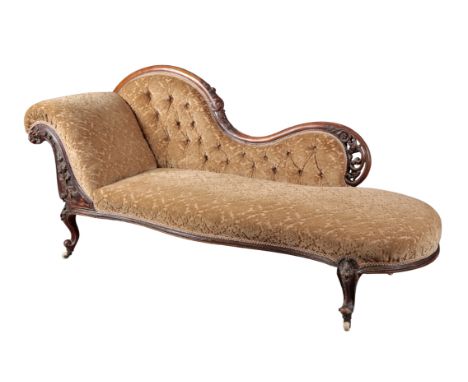 A VICTORIAN WALNUT CHAISE LONGUE with carved and pierced show wood frame, upholstered in leaf cut moquette, on cabriole legs 