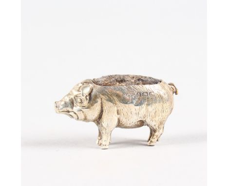 A MINIATURE PIG PIN CUSHION. Birmingham 1909.  3.5cms long.