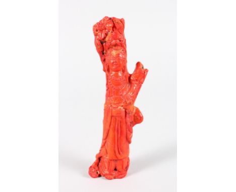 A CARVED RED JADE FIGURE OF GUANYIN. 7.5ins long.