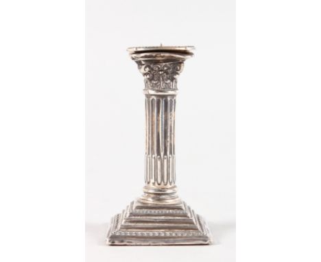 A CORINTHIAN COLUMN SILVER CANDLESTICK.  7cms high.