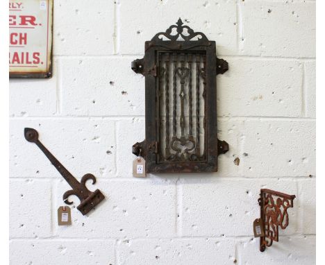 A WROUGHT IRON WINDOW GRILL, BRACKET AND HINGE (3).