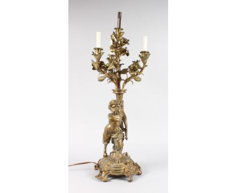 A GOOD ORMOLU LAMP, modelled as a young faun holding aloft a cornucopia with four scrolling branches. 2ft 10ins high.