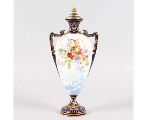 A ROYAL WORCESTER TWO HANDLED URN SHAPED VASE AND COVER, with leaded glaze, lake scene, and painted with flowers within blue 