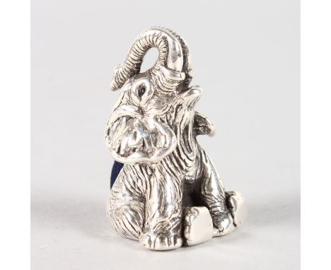 A SILVER SEATED ELEPHANT PIN CUSHION.