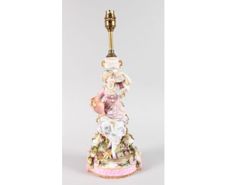 A 19TH CENTURY FRENCH PORCELAIN LAMP, a young girl with a pitcher beside a column. 30cms high.