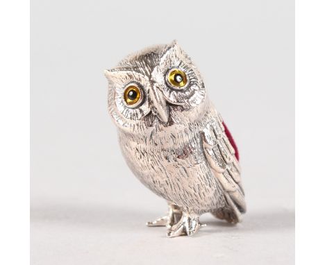 A SMALL SILVER NOVELTY OWL PIN CUSHION.