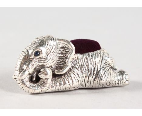 A SILVER LYING ELEPHANT PIN CUSHION.