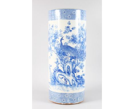 A LARGE JAPANESE BLUE AND WHITE STICK STAND decorated with peacock and flowers trees. 2ft high.