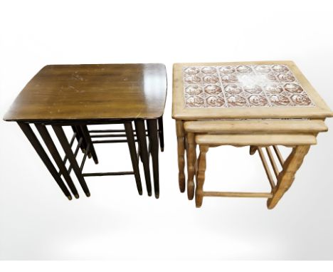 A Danish blonde oak nest of three tile set inset tables and a further nest of tables.