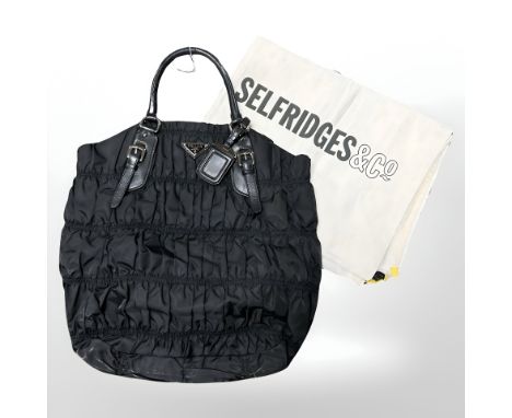 Prada: A black nylon Tessuto Gaufre tote bag, with authenticity card, numbered BN 1611, with Selfridges dust bag.