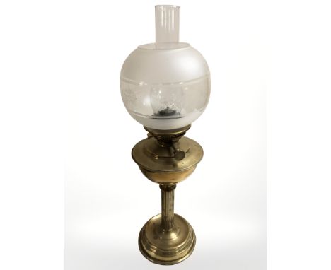 A brass oil lamp with etched glass shade, height 63 cm.