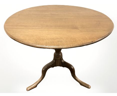 A reproduction oak circular tripod table, diameter 89 cm.