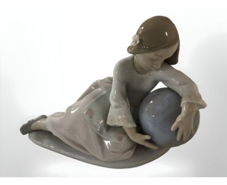 A Lladro figure of a girl leaning on a globe, length 21 cm 